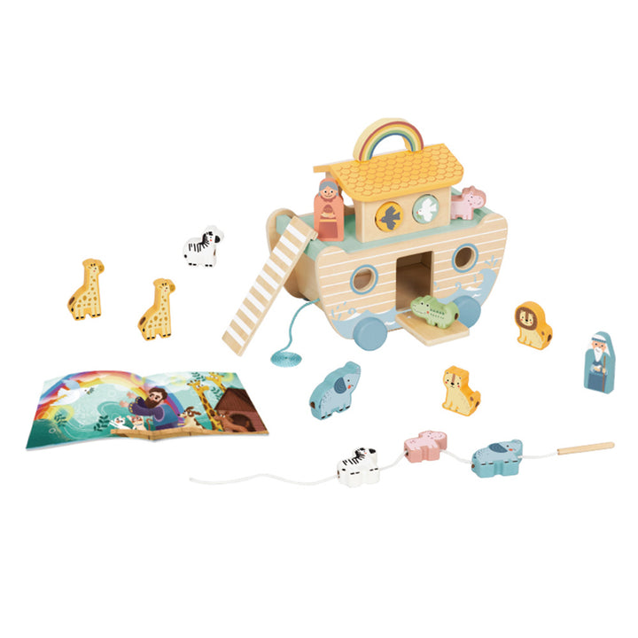 Wooden toy Noah's Ark with pull toys and book on a white background