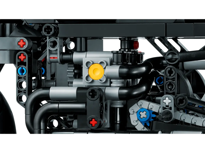 Close-up of a LEGO Technic model with mechanical components on a white background