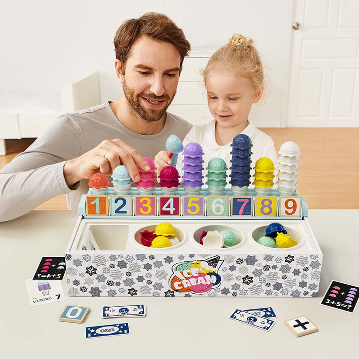 Man and young girl playing with an ice cream-themed educational toy