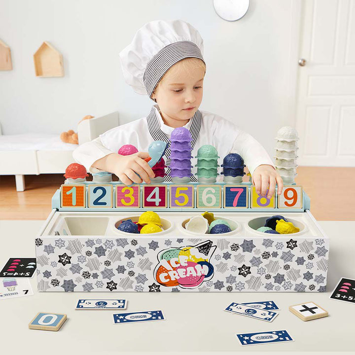 Child playing with an ice cream-themed toy set in a kitchen-like setting