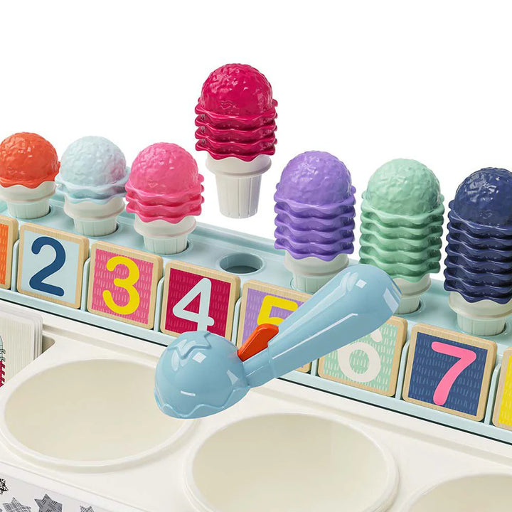 Colorful ice cream toy set with numbered blocks and a scoop on a white background