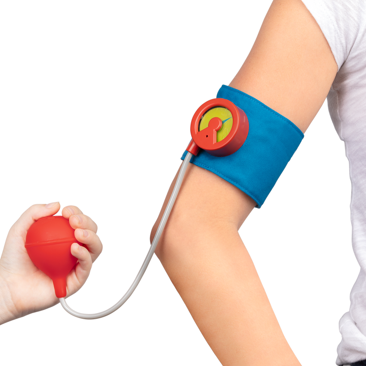 Toy blood pressure monitor on a child's arm with a hand holding the pump against a white background