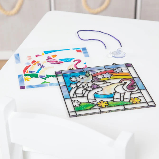 Colorful stained glass art project on a white tablecloth